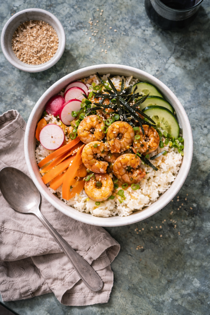 Overhead photo of an easy shrimp donburi rice bowl with fresh vegetables for a quick weeknight dinner