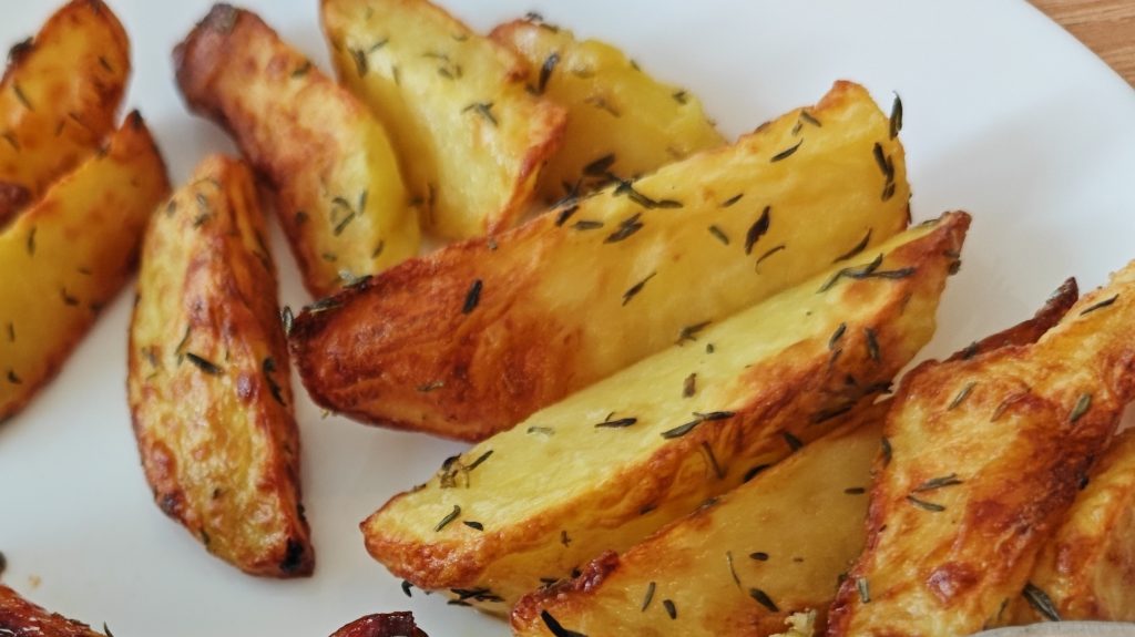 roasted potato wedges with crispy edges and herbs as an alternative to baby potatoes