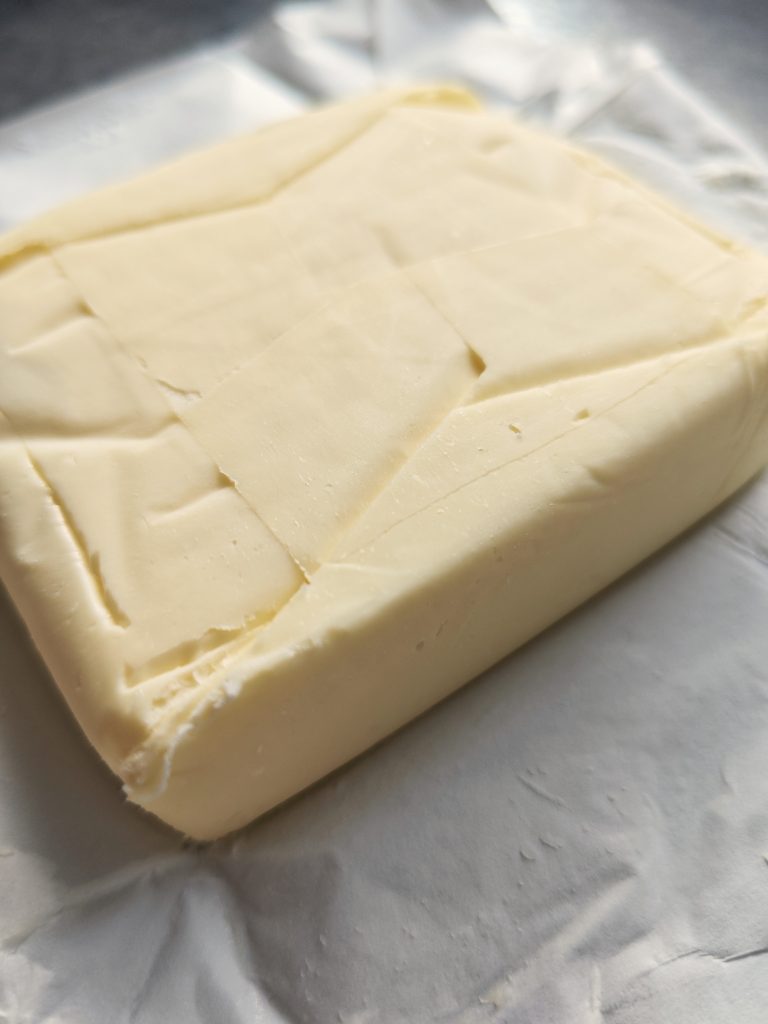 block of real butter showing firm texture and clean cut, minimum 80 percent milk fat recommended for best results